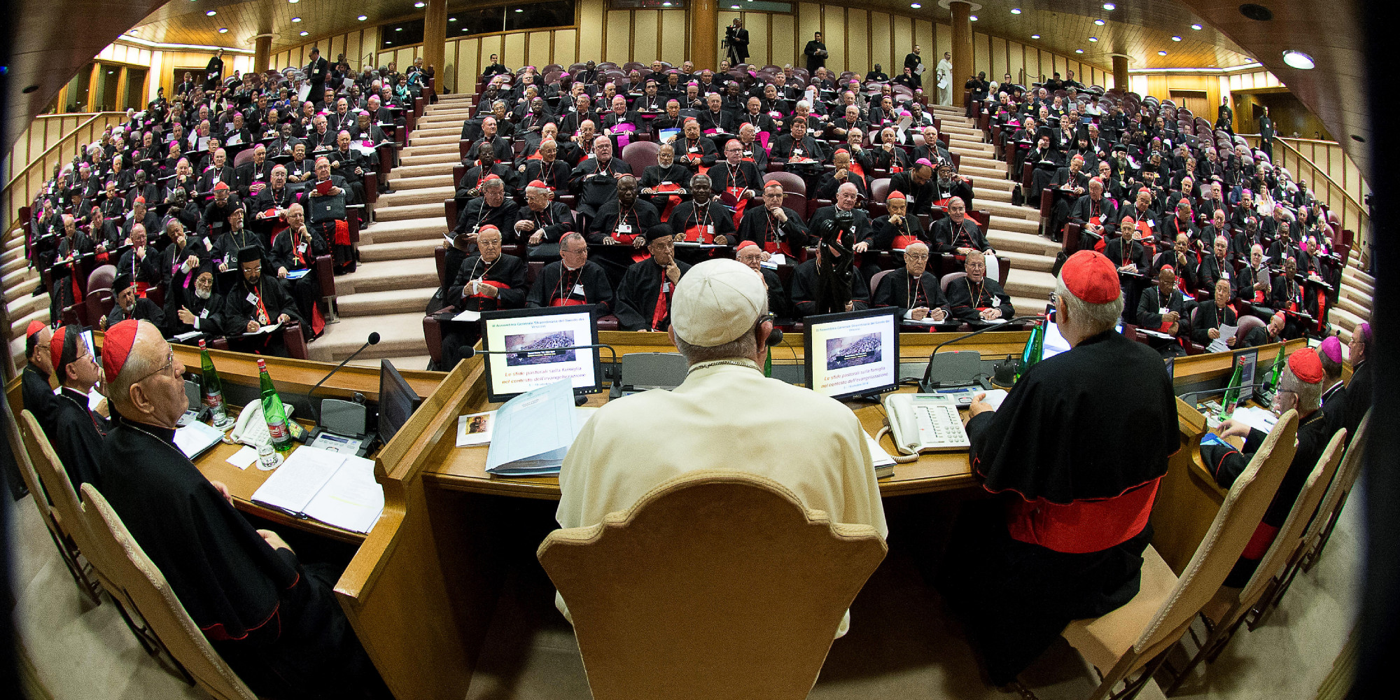 A handout picture released by the Vatican press office show Pope Francis (C) chairing an extraordinary synod of nearly 200 senior clerics in the Synod Aula at the Vatican on October 6, 2014. Pope Francis issued a strong signal of support for reform of the Catholic Church's approach to marriage, cohabitation and divorce as bishops gathered for a landmark review of teaching on the family. Thorny theological questions such as whether divorced and remarried believers should be able to receive communion will dominate two weeks of closed-door discussions set to pit conservative clerics against reformists. AFP PHOTO / OSSERVATORE ROMANO == RESTRICTED TO EDITORIAL USE - MANDATORY CREDIT "AFP PHOTO / OSSERVATORE ROMANO" - NO MARKETING NO ADVERTISING CAMPAIGNS - DISTRIBUTED AS A SERVICE TO CLIENTS ==