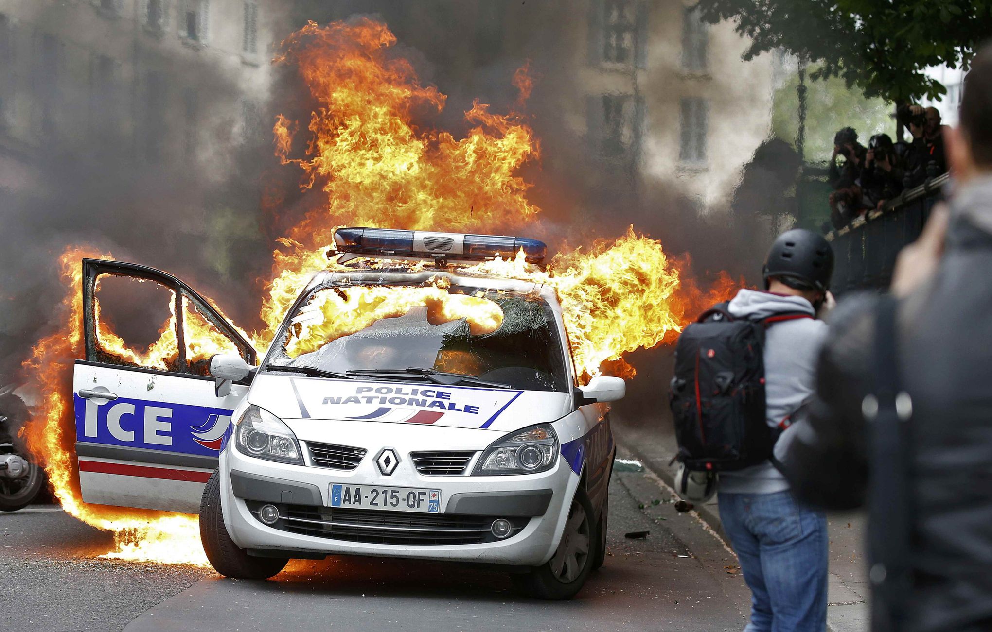 A police car burns during a demonstration against police violence and against French labour law reform in Paris, France, May 18, 2016. REUTERS/Charles Platiau